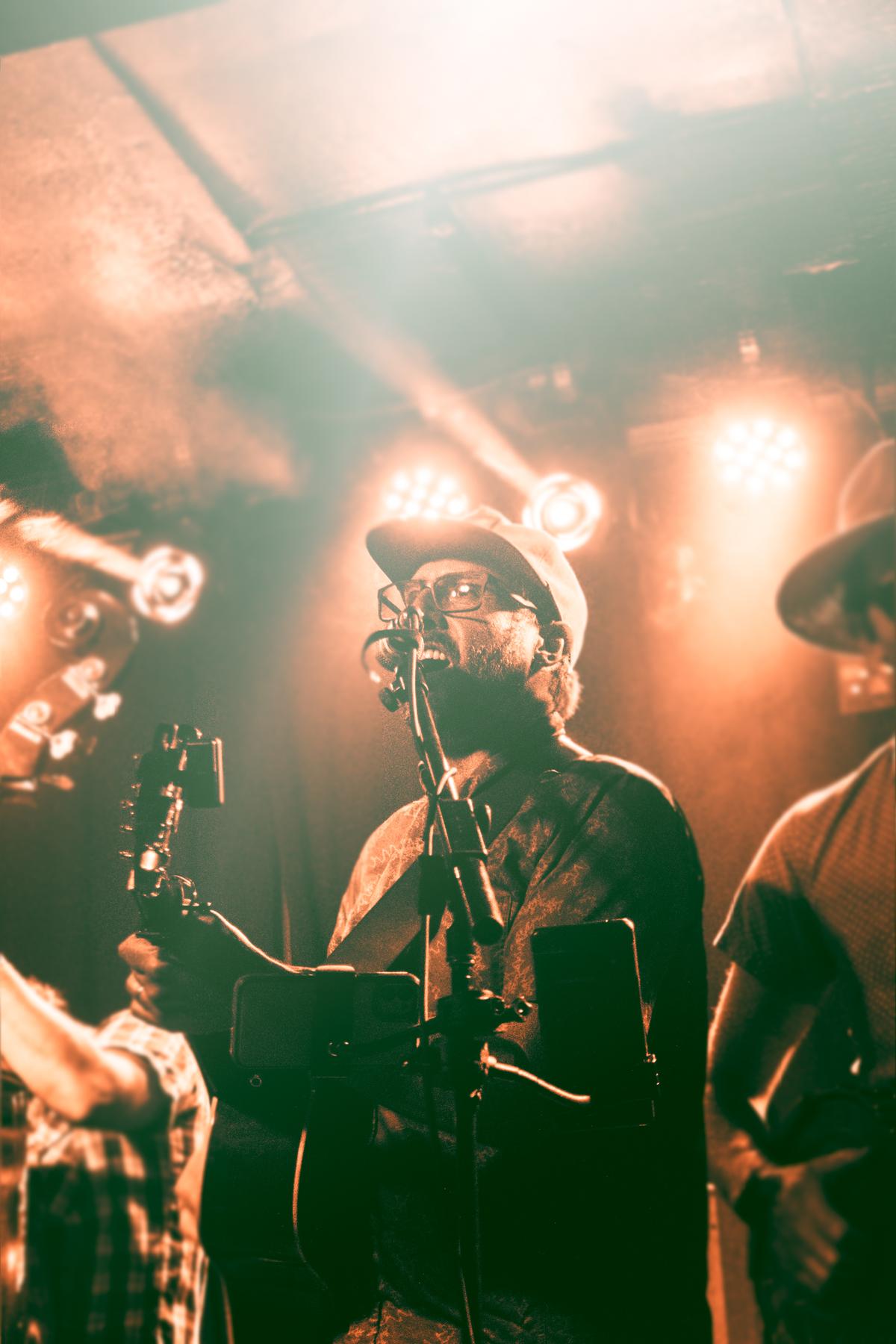 Tyler playing guitar and singing at Moe's.